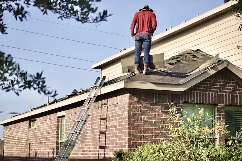 Professional roofer working on a residential roof in McGuffey Heights